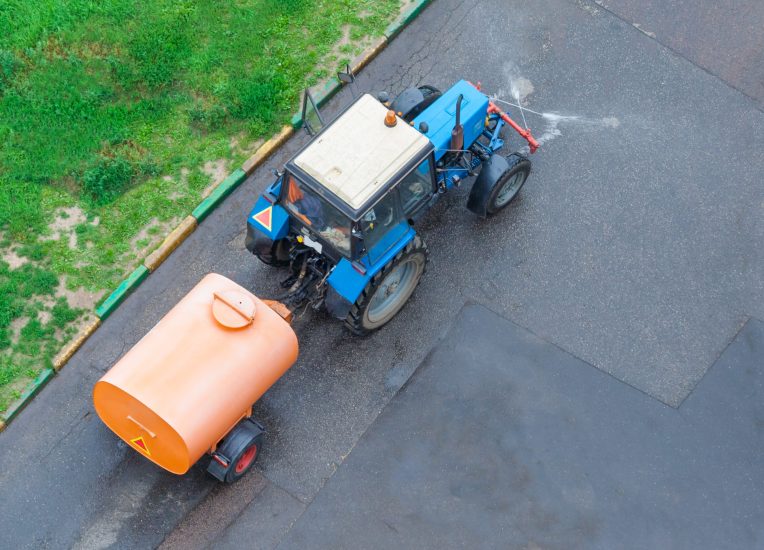Aerial view on a truck with tank for washing the street with copy space